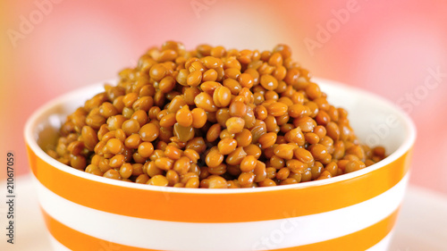 Lentil beans, healthy source of dietary fibre and protein, in bowl closeup.