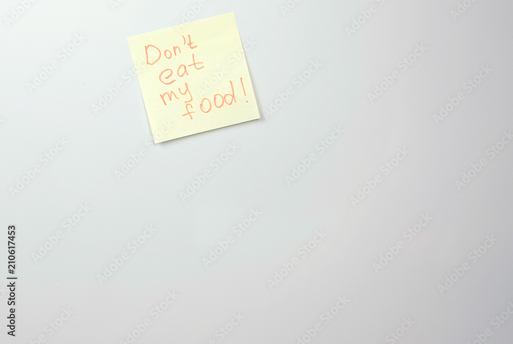 Note on yellow sticker paper sheets with words don't eat my food on