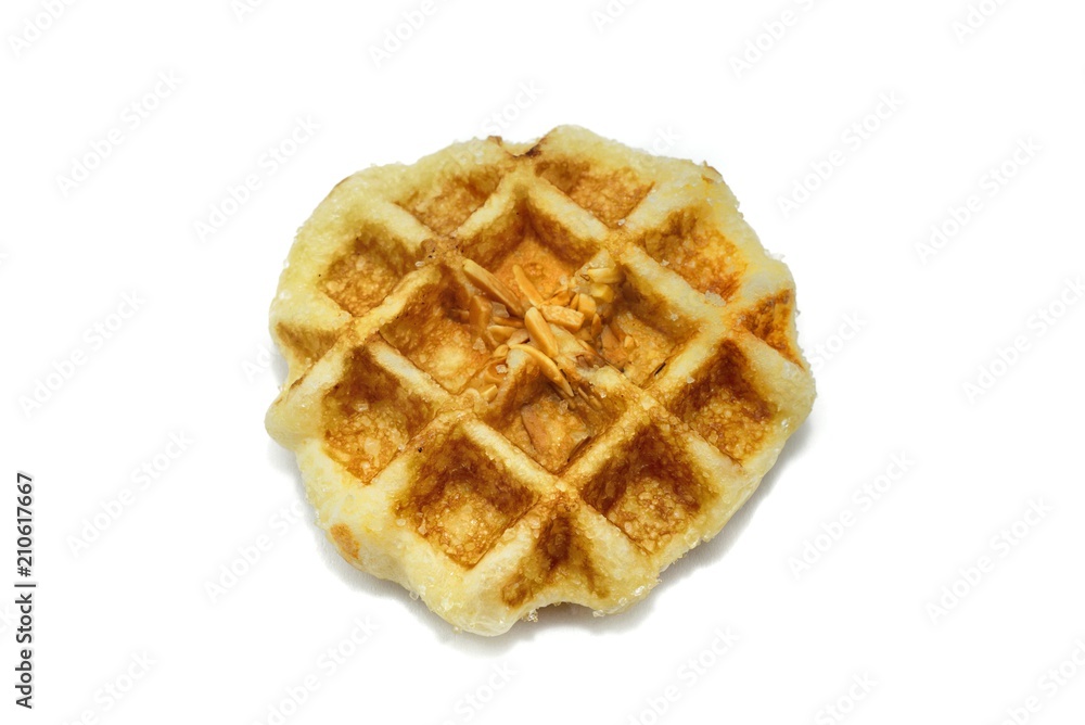 Waffle with caramel sauce and almond isolated on white background. space for your text. Waffle with caramel sauce and almond isolated on white background. space for your text.