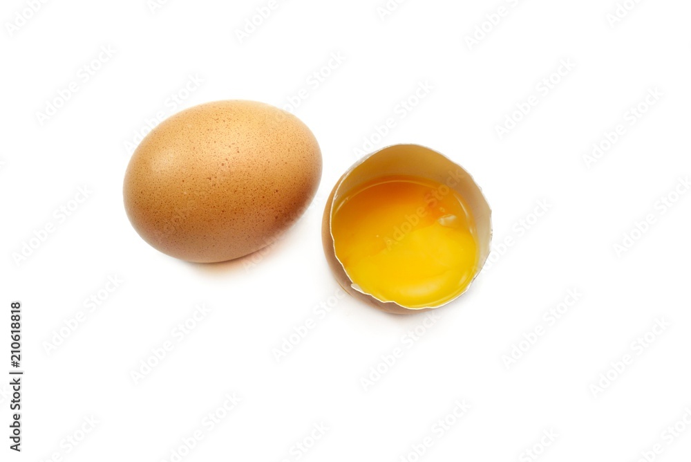 Top view of egg with egg yolk in egg shell isolated on black background. Copy space