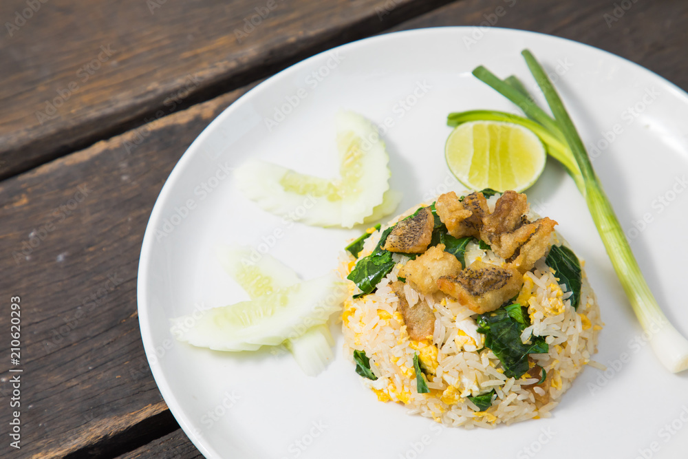 Fried rice with Fried Fish on the wooden table from top view Fried rice with Fried Fish on the wooden table from top view