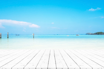 Perspective empty white pearl wooden table on top over blur background, can be used mock up for montage products display or design layout.