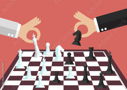 Two business people playing chess