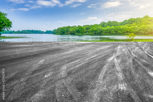 The empty asphalt road square and natural landscape in the setting sun photo