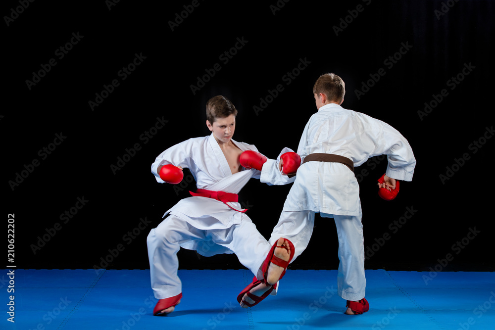 The studio shot of group of kids training karate martial arts