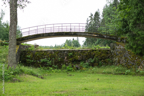 Old bridge, lake locks and green grass. photo