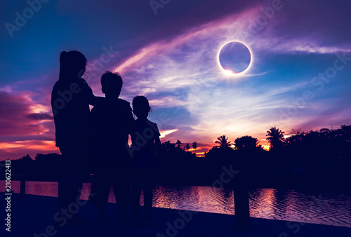 Natural phenomenon. Three person looking at total solar eclipse. photo
