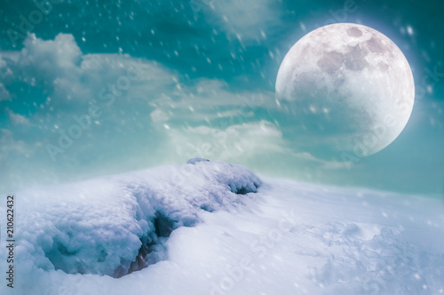 Landscape at snowfall with super moon. Serenity nature background.
