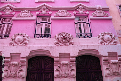 Bright colorful facade of old European building with windows .