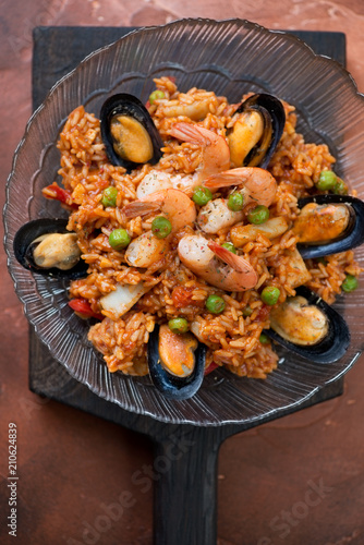 Above view of spanish paella with seafood, vertical shot, closeup