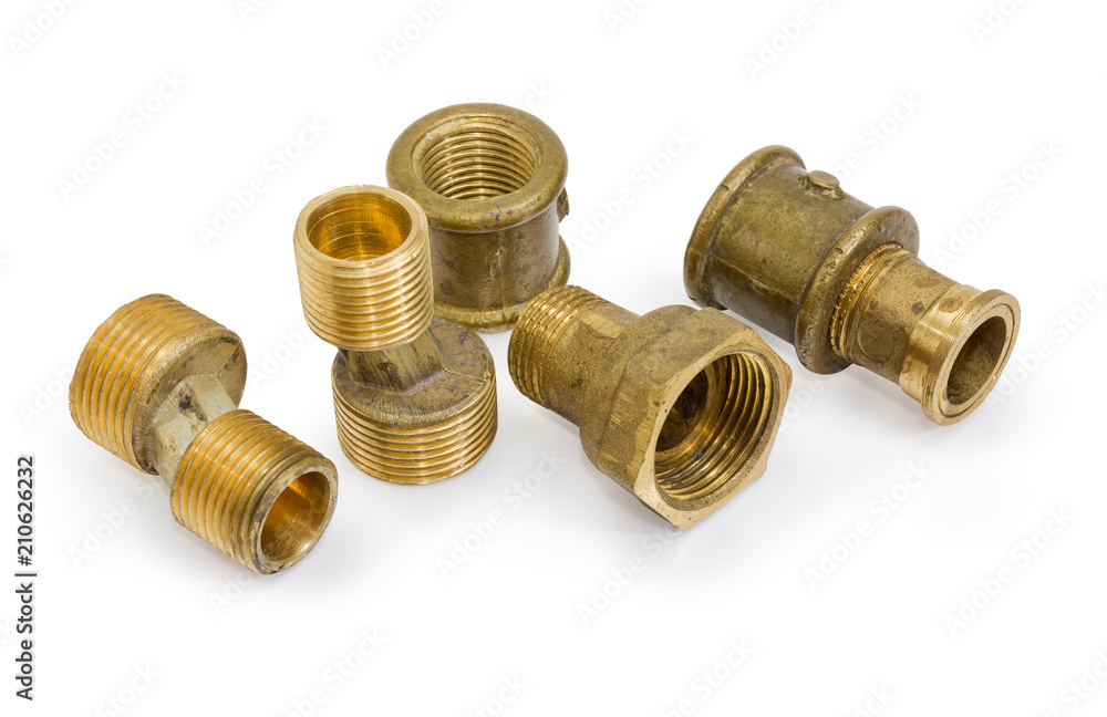 Different brass pipe fittings and plumbing components on white background Different brass pipe fittings and plumbing components on white background