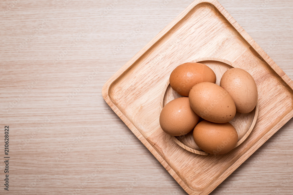 Close-up view of chicken eggs on wooden table background Close-up view of chicken eggs on wooden table background