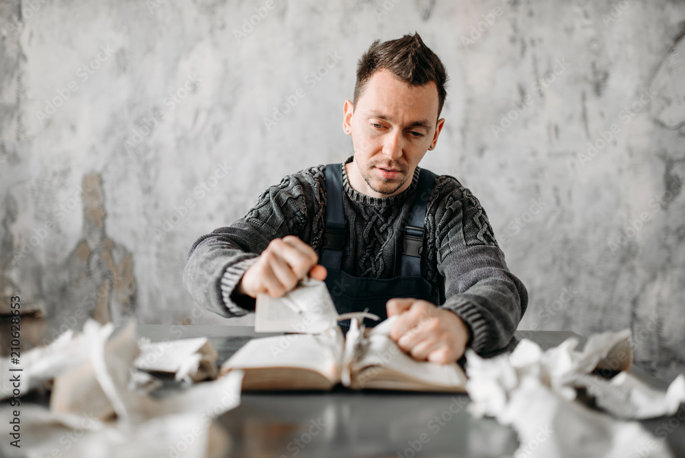 Strange freak man rips the sheets from book