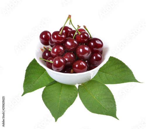 Sour cherry on a green leaf isolated on white background