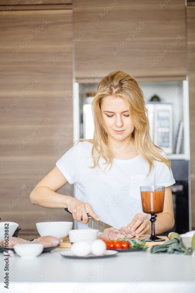 Young attractive female arranging all foodstuff from ref on kitchen table, creating healthy delicious dish. Young attractive female arranging all foodstuff from ref on kitchen table, creating healthy delicious dish.