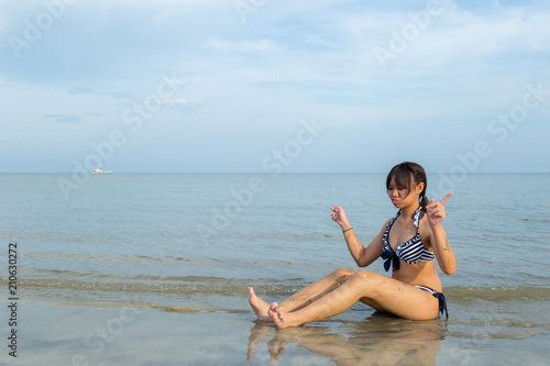 Teenage wearing bikini at the beach.
