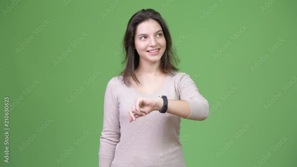 Young happy beautiful woman thinking while checking time Young happy beautiful woman thinking while checking time