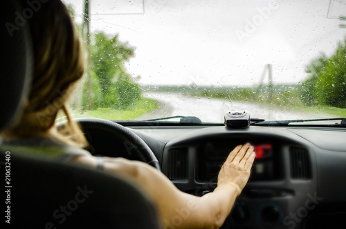 girl driving a car rides along the road