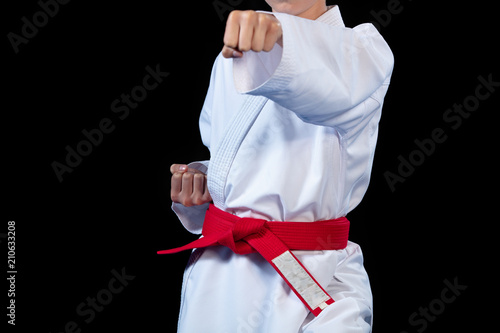 Aikido red belt on white kimono on black background