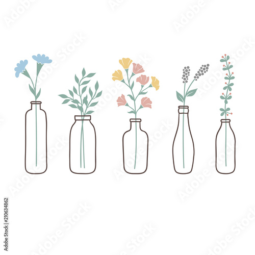 Set of bottles with cute pastel wild flowers and grasses