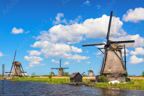 Famous windmills in Kinderdijk village in Holland. Colorful spring rural landscape in Netherlands, Europe. UNESCO World Heritage and famous tourist site.