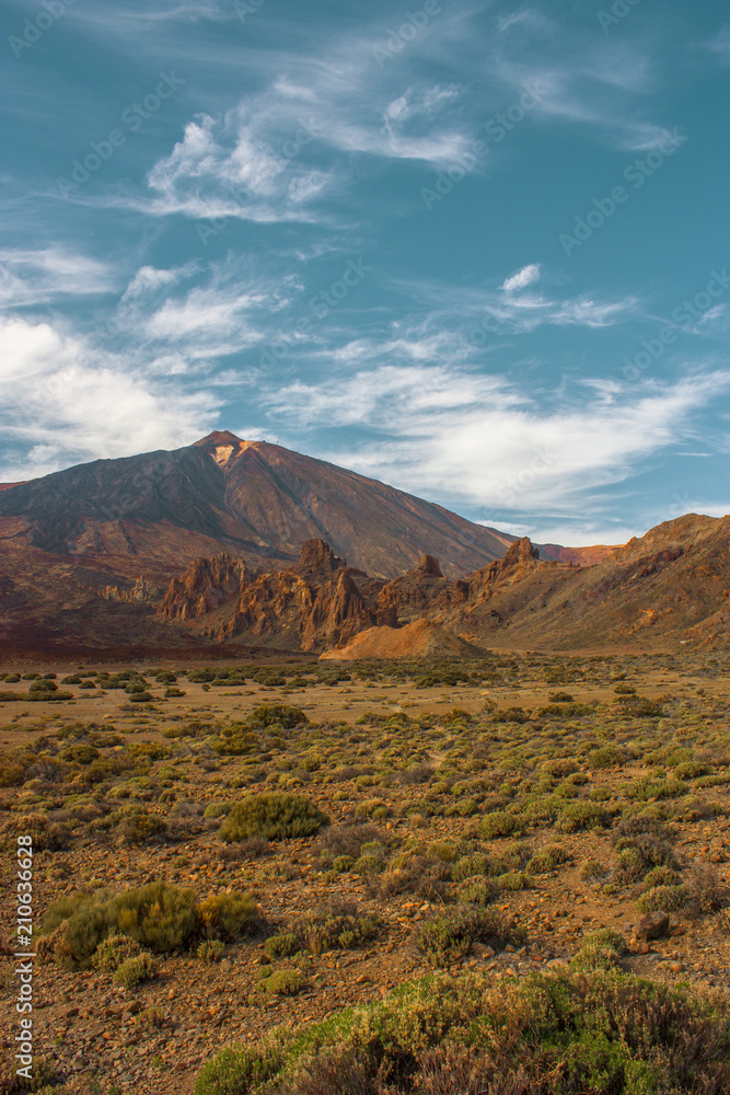 Teide National Park. Beautiful view of volcano mountain rocks desert crater and El Teide, the highest volcano in the Atlantic Ocean Canary islands on a sunny day and blue sky. Tenerife, Canary Islands