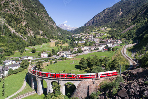 Bernina Express, red train of Bernina over the viaduct of Brusio, Unesco heritage photo