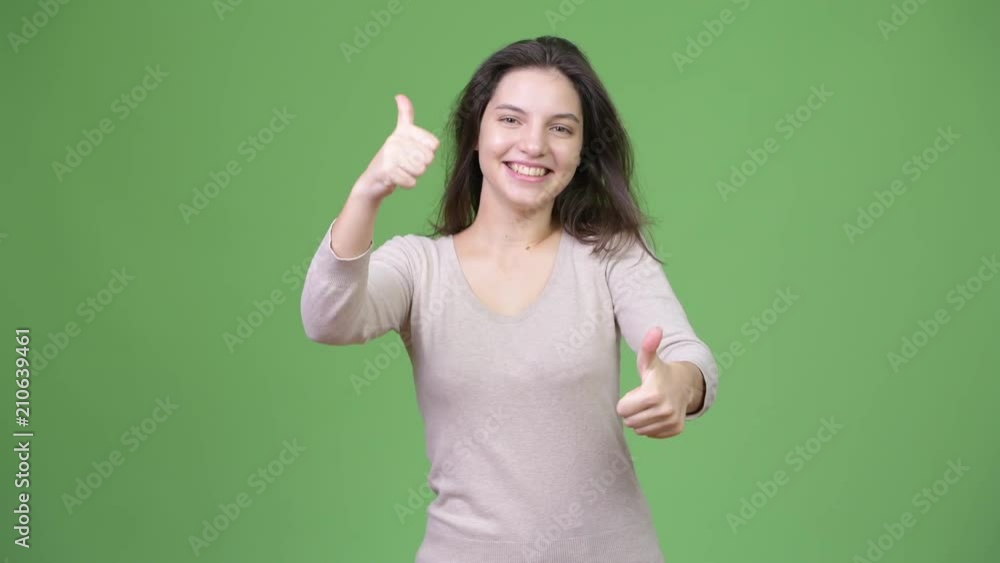 Young happy beautiful woman smiling while giving two thumbs up Young happy beautiful woman smiling while giving two thumbs up
