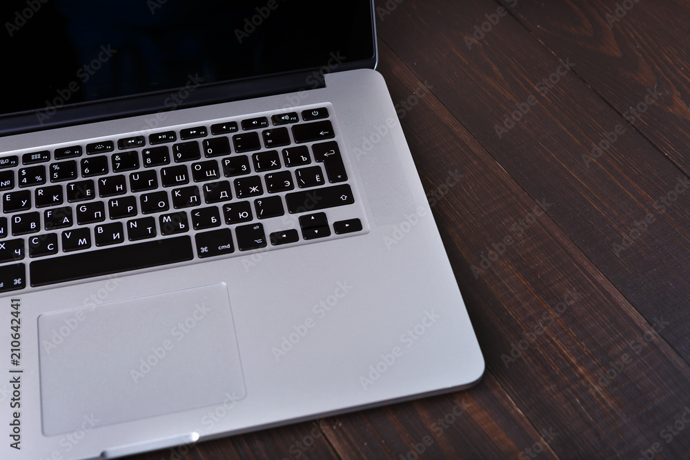 Laptop keyboard on the brown wooden desk. Space for text Laptop keyboard on the brown wooden desk. Space for text
