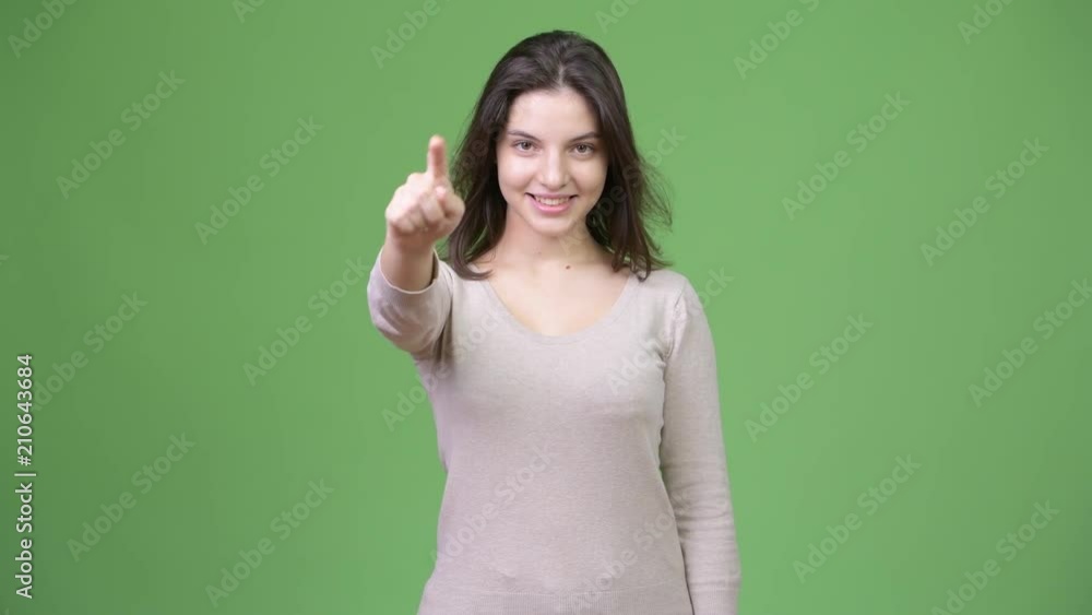 Young happy beautiful woman pointing to camera Young happy beautiful woman pointing to camera