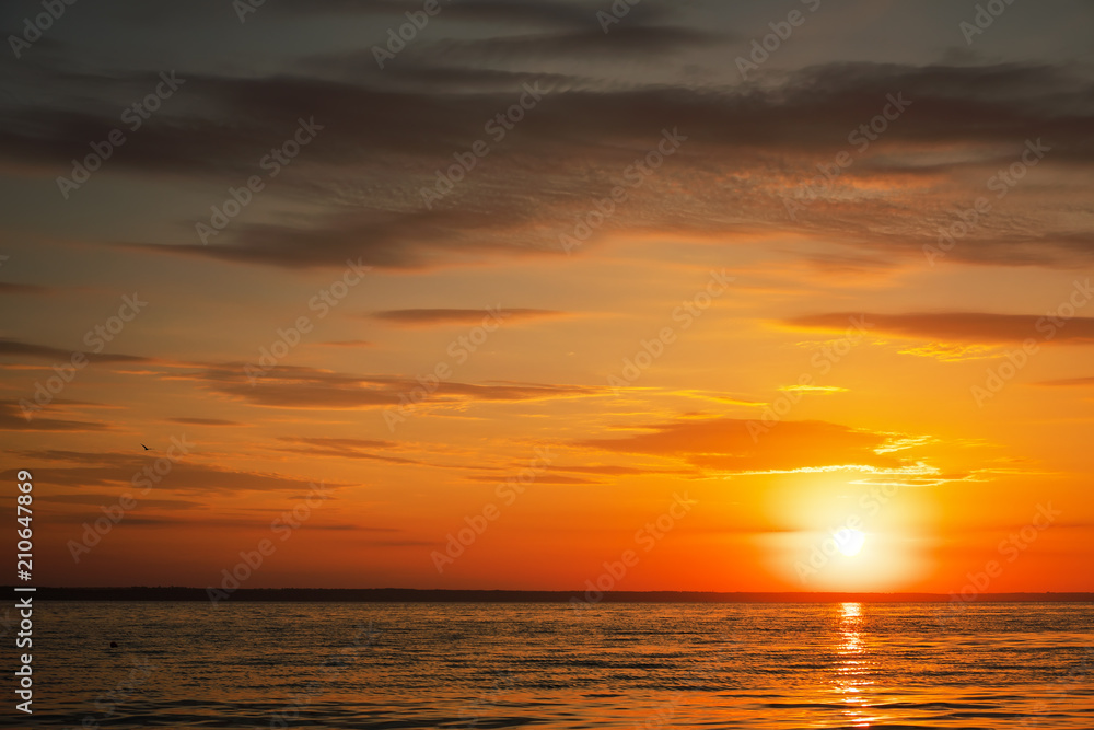 Beautiful fiery sunset sky on the beach. Composition of nature