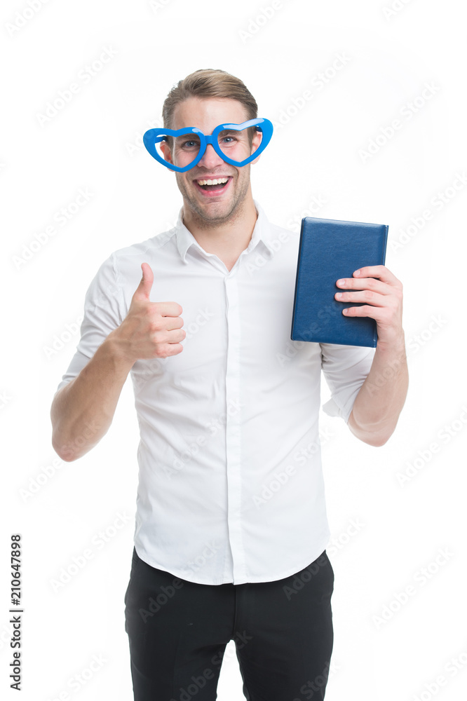 I love reading books. Man cute nerd in heart shaped glasses loves to read books. Guy holds book and shows thumbs up, isolated white. I always read at least few pages every day. My favorite book
