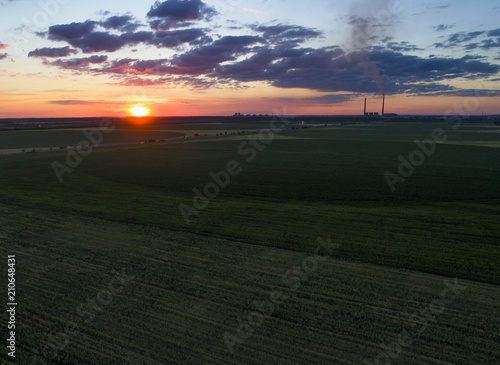 Green Field and colorful sunset. Aerial photo, made by drones
