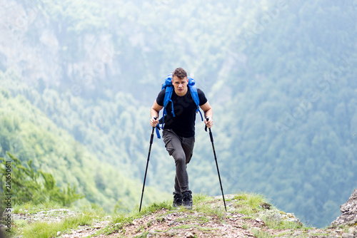 Hiker with backpack walking in nature