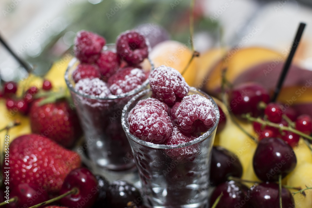 Raspberry in a glass of wine sprinkled with powdered sugar Raspberry in a glass of wine sprinkled with powdered sugar