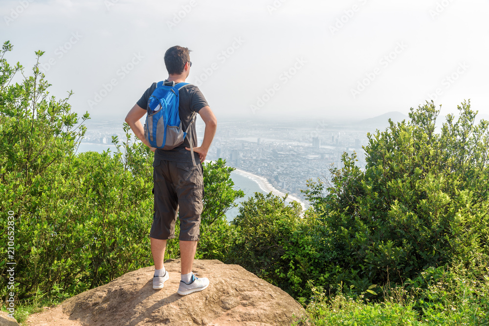 Tourist enjoying beautiful view from top of mountain