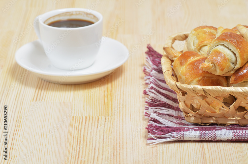 Homemade croissants in a wicker basket on a wooden table Homemade croissants in a wicker basket on a wooden table