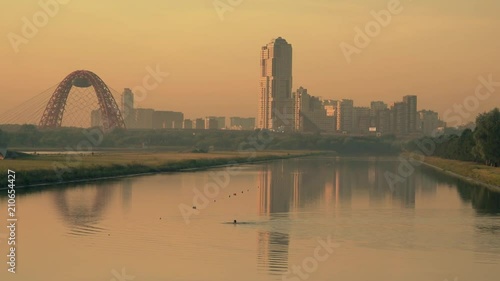 Scenic Moscow cityscape in the evening involving cable-stayed Zhivopisny Bridge and Krylatskoye Rowing Canal, Russia photo