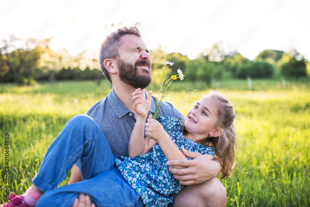 Fototapeta premium Father with a small daughter having fun in spring nature.