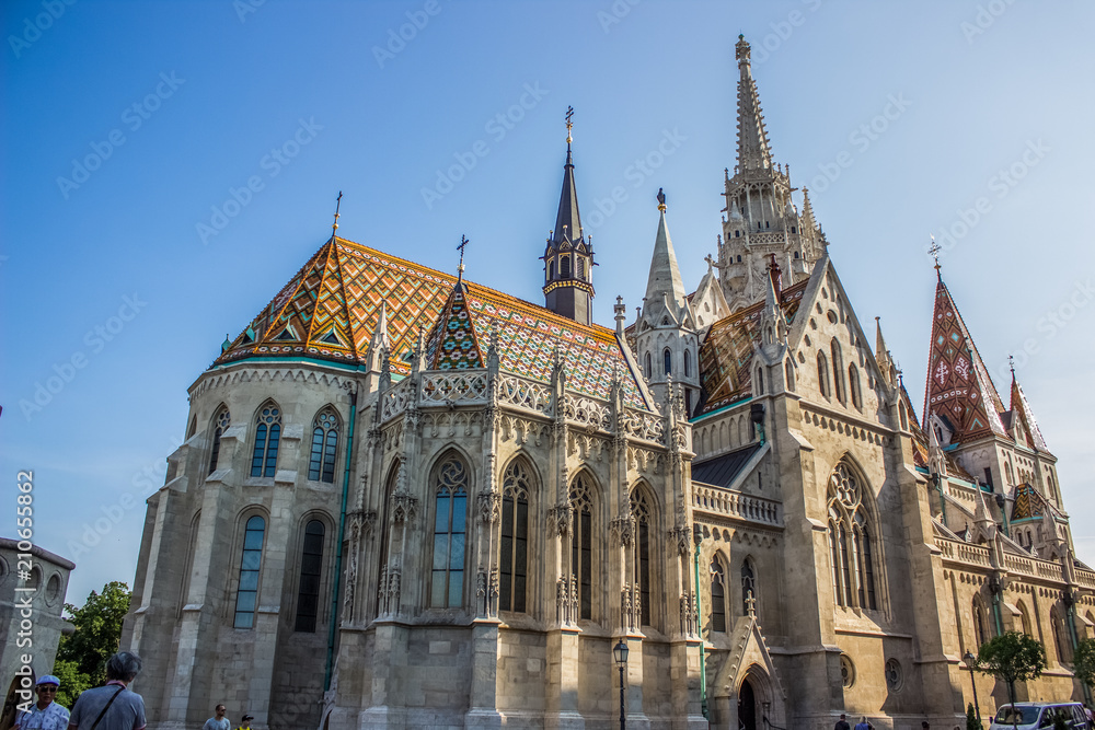 Fototapeta premium white gothic church with towers on blue sky background in summer time bright colorful day