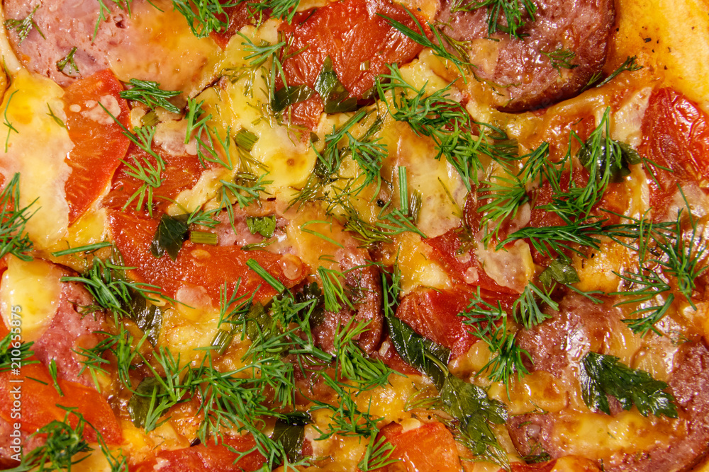 Close-up of homemade delicious pizza with salami, tomatoes and dill Close-up of homemade delicious pizza with salami, tomatoes and dill