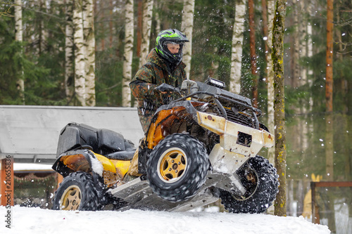 Extreme ATV rider gets on snow hill
