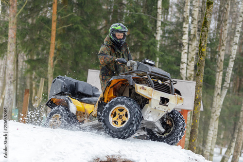 Extreme ATV riding down the snowy hill