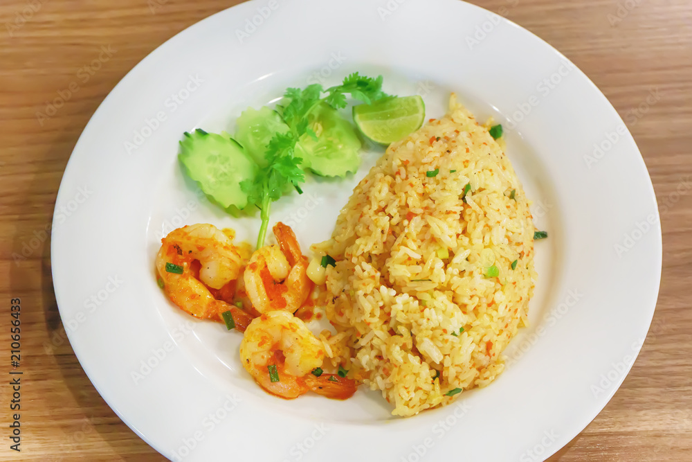 Fried Rice with Shrimp Paste in white dish on the wooden floor. Fried Rice with Shrimp Paste in white dish on the wooden floor.