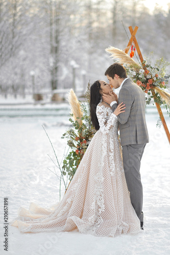 Winter wedding European bridegroom and Asian bride