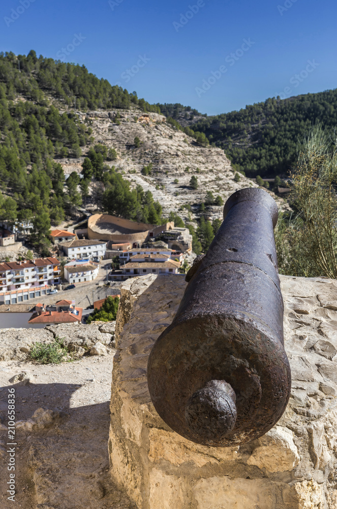 Panoramic view of the city, at the bottom of the bullring in the form of a boat, artillery cannon from the castle, fortress of Almohad origin, take on Alcala del Jucar, Spain