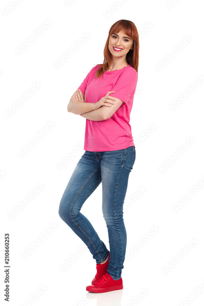 Casual Young Woman Standing With Arms Crossed, Smiling And Looking At Camera Casual Young Woman Standing With Arms Crossed, Smiling And Looking At Camera