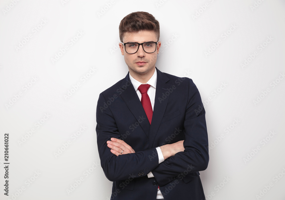 portrait of confident businessman standing with hands crossed portrait of confident businessman standing with hands crossed