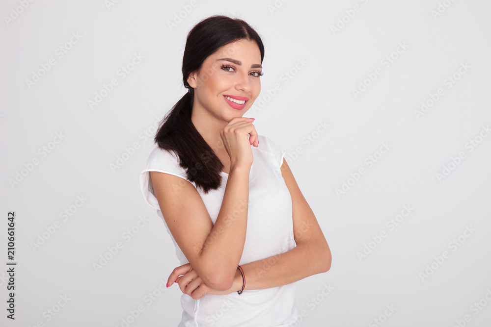 portrait of attractive woman in white t-shirt smiling and thinking portrait of attractive woman in white t-shirt smiling and thinking