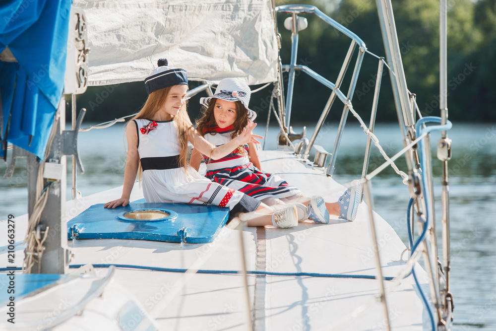 Obraz premium The children on board of sea yacht